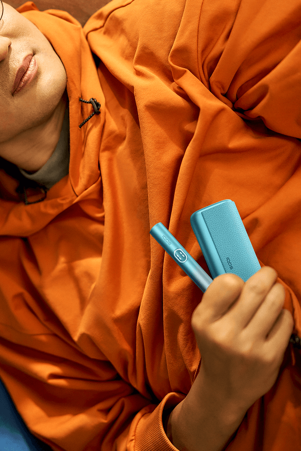 A person holding an ILUMA i PRIME Blue
